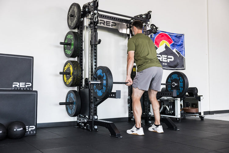 power rack with front foot extension pair 2.0 adding stability to front of rack while someone lifts off of spotter arms