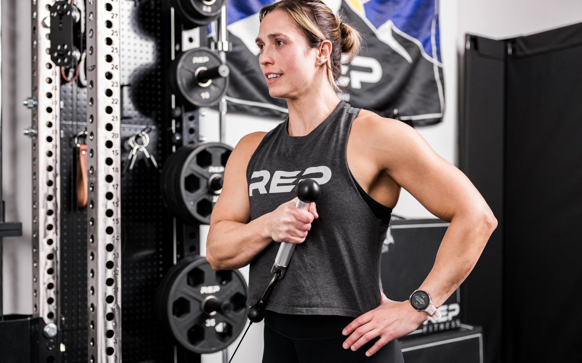 An athlete using the REP® x Kleva Built® ISO Pushdown Grip Cable Attachment to perform hammer curls