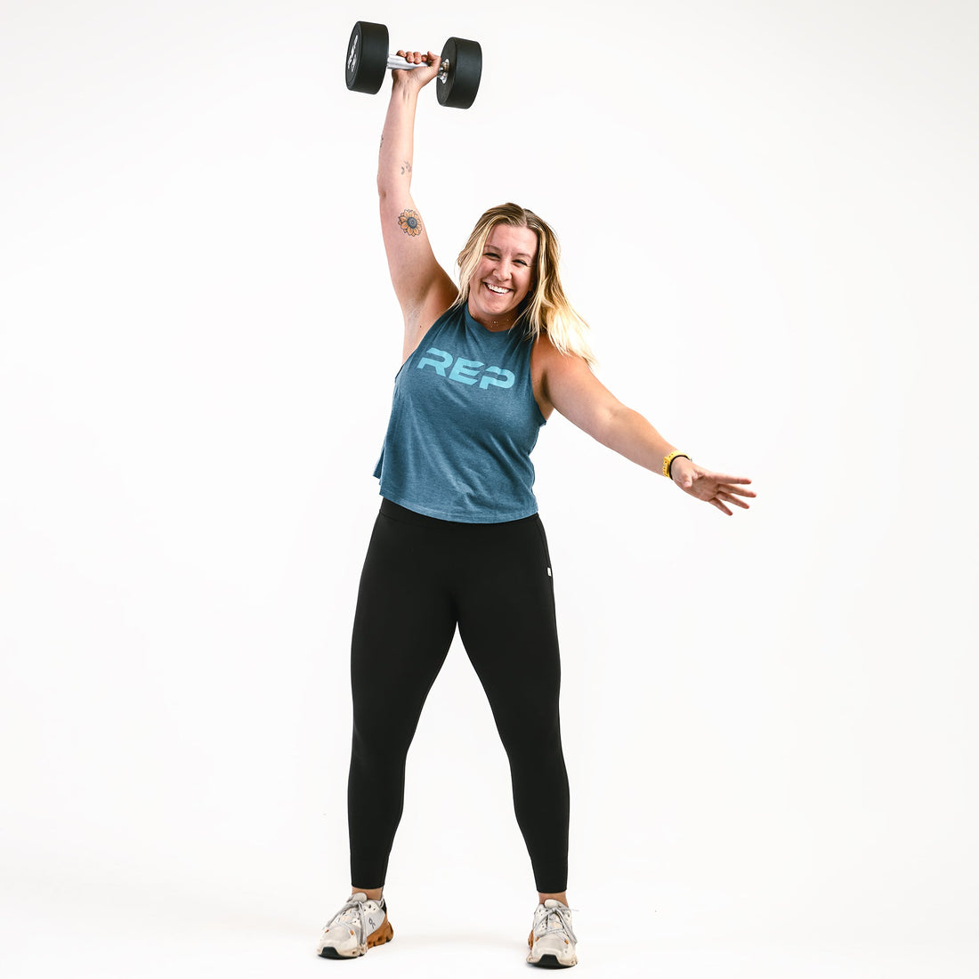 Athlete does a dumbbell snatch.