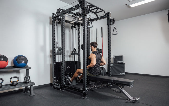 Man doing low rows sitting on a bench using the Ares 2.0